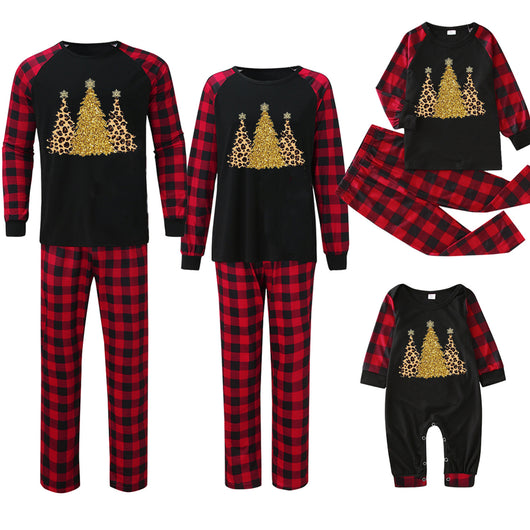 Matching family Christmas pajamas with black tops, red and black plaid sleeves, and glittery leopard print Christmas trees. - Image 12