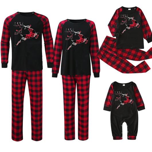 Matching family Christmas pajamas with black tops, red and black plaid sleeves, and glittery leopard print Christmas trees. - Image 16