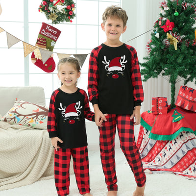 Family matching Christmas pajamas with black tops featuring a wine glass in a Santa hat graphic and red plaid bottoms. - Image 10