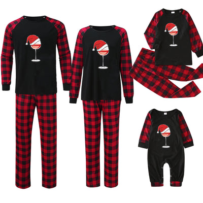 Family matching Christmas pajamas with black tops featuring a wine glass in a Santa hat graphic and red plaid bottoms. - Image 11