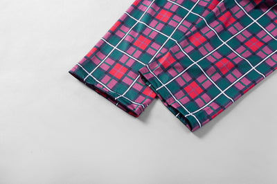 Family of five and a Boston Terrier wearing matching green long-sleeved Christmas pajamas with reindeer graphic and red plaid pants. - Image 10