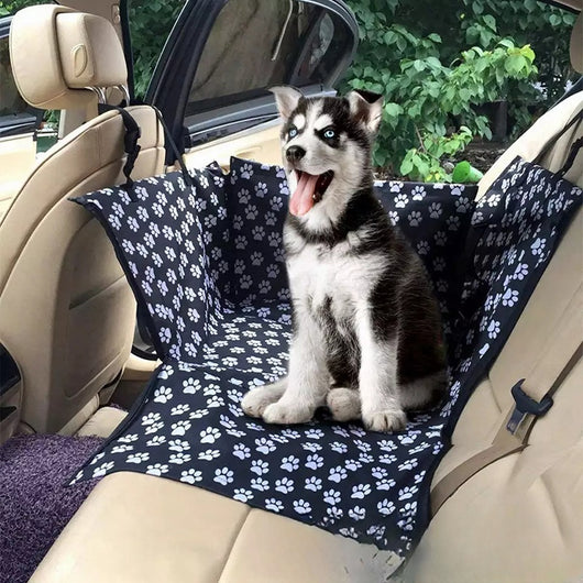 Brown pet car mat with colorful dog pattern installed in a car's rear seat, protecting upholstery. - Image 24