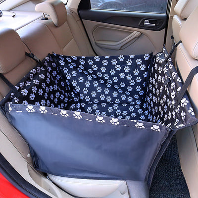 Brown pet car mat with colorful dog pattern installed in a car's rear seat, protecting upholstery. - Image 29