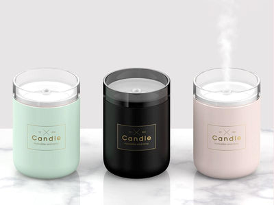 Light pink mini USB humidifier diffuser, shaped like a candle, with a clear top and visible mist output. - Image 10