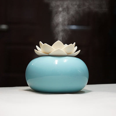 White ceramic lotus aromatherapy humidifier emitting a fine mist, perfect for home or office decor. - Image 7