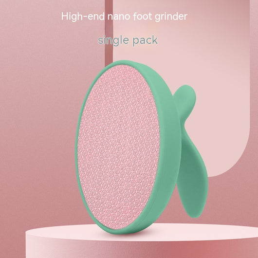 Pink oval nano foot grinder with a textured surface and ergonomic handle, designed for exfoliating and removing calluses. - Image 9