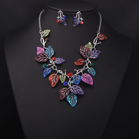 Blue enamel leaf necklace and matching earrings set with silver-tone vines and sparkling rhinestones, displayed on a black mannequin. - Image 2