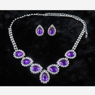 Purple teardrop rhinestone necklace and matching stud earrings set on a black background. - Image 11