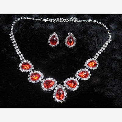 Purple teardrop rhinestone necklace and matching stud earrings set on a black background. - Image 23