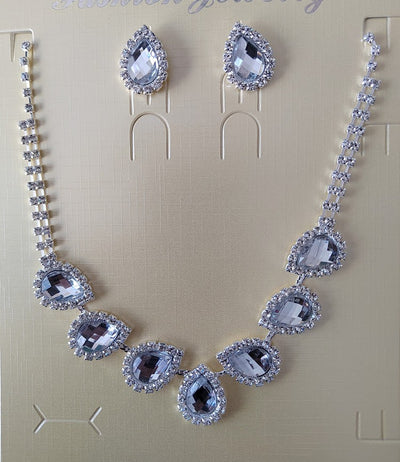 Purple teardrop rhinestone necklace and matching stud earrings set on a black background. - Image 27