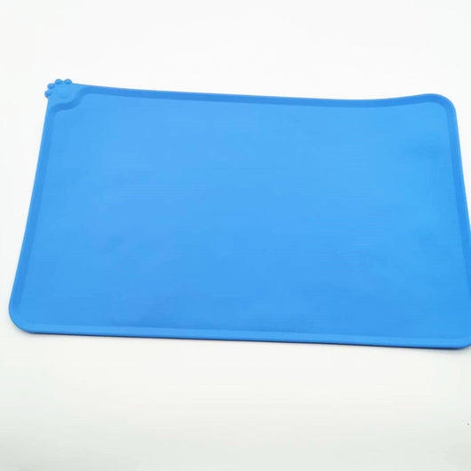 Blue rectangular silicone pet placemat with a raised edge and a small paw print detail in the corner. - Image 19