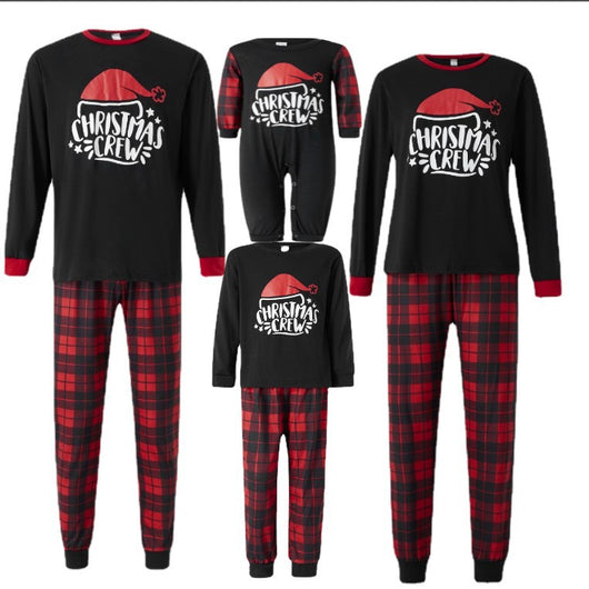 Family of four wearing matching red and black plaid Christmas pajamas with "Christmas CREW" graphic, children in Santa hats. - Image 12