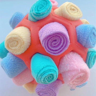 Red rubber pet sniff ball with pink, purple, and dark purple fleece rolls, featuring a treat-holding strap. - Image 29