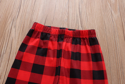 Christmas pajama set with a white long-sleeve top featuring Santa, reindeer, and penguin, and red and black plaid pants. - Image 17