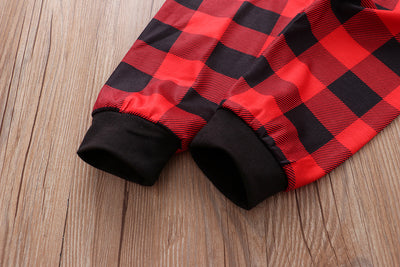 Christmas pajama set with a white long-sleeve top featuring Santa, reindeer, and penguin, and red and black plaid pants. - Image 18