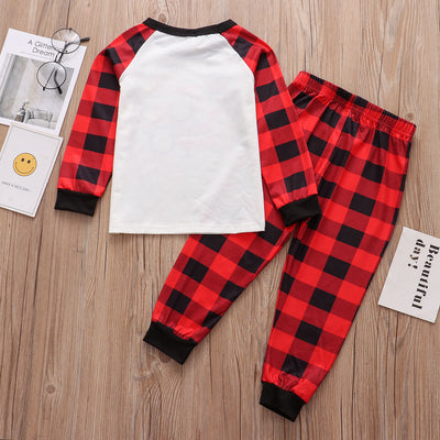 Christmas pajama set with a white long-sleeve top featuring Santa, reindeer, and penguin, and red and black plaid pants. - Image 21