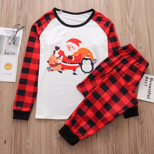 Christmas pajama set with a white long-sleeve top featuring Santa, reindeer, and penguin, and red and black plaid pants. - Image 22