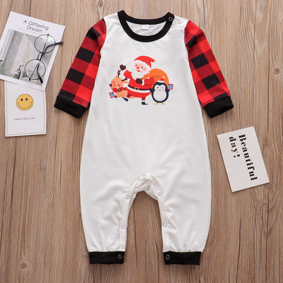Christmas pajama set with a white long-sleeve top featuring Santa, reindeer, and penguin, and red and black plaid pants. - Image 27