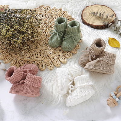 Pink knitted infant toddler shoes with cute bowknots and elastic bands, displayed on a soft white rug. - Image 11