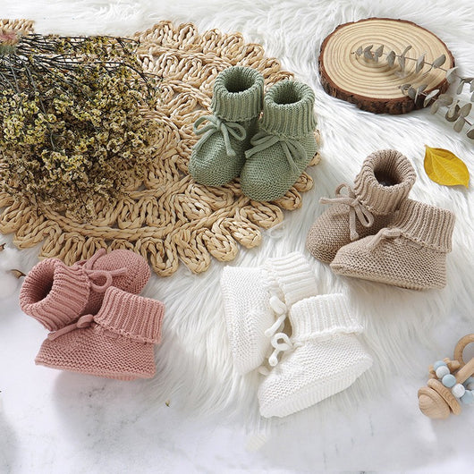 Pink knitted infant toddler shoes with cute bowknots and elastic bands, displayed on a soft white rug. - Image 11