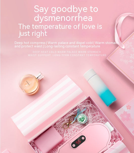 Pink stomach warming belt with vibration and heating, USB charging cable, two wormwood bags, and manual in a floral gift box. - Image 8
