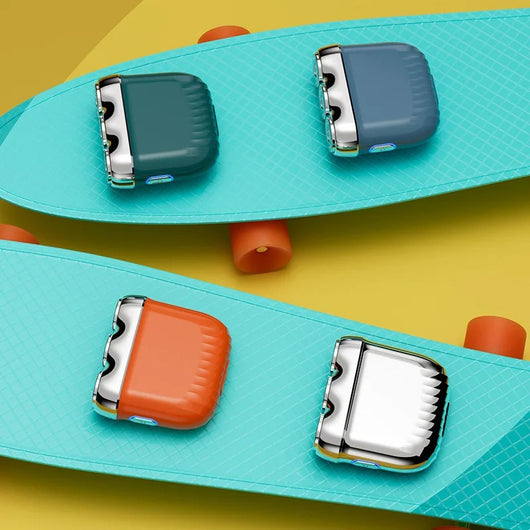 Orange mini electric shaver with three silver floating cutter heads, a blue power button, on a translucent orange block. - Image 19