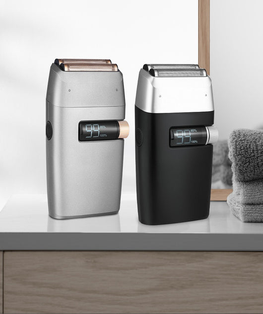 Silver electric shaver with a rose gold power button and LCD display showing '99', next to a replacement shaver head. - Image 10