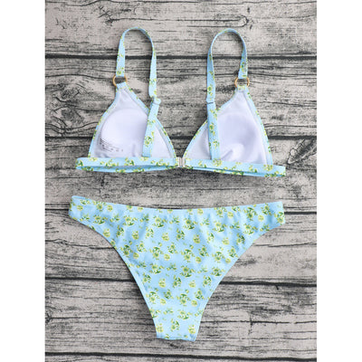 Woman smiling in a white bikini with blue floral print, triangle top, and briefs bottoms, on a sunny beach. - Image 55