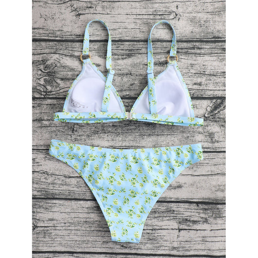 Woman smiling in a white bikini with blue floral print, triangle top, and briefs bottoms, on a sunny beach. - Image 55