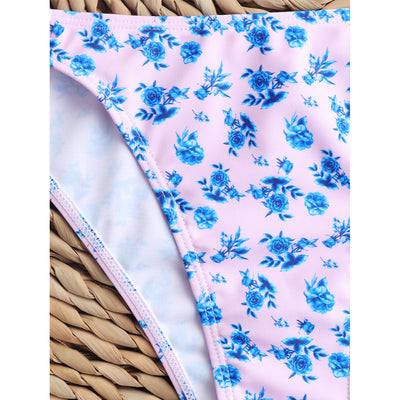 Woman smiling in a white bikini with blue floral print, triangle top, and briefs bottoms, on a sunny beach. - Image 57