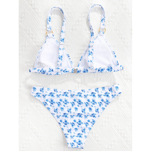 Woman smiling in a white bikini with blue floral print, triangle top, and briefs bottoms, on a sunny beach. - Image 59