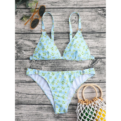 Woman smiling in a white bikini with blue floral print, triangle top, and briefs bottoms, on a sunny beach. - Image 83