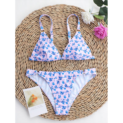 Woman smiling in a white bikini with blue floral print, triangle top, and briefs bottoms, on a sunny beach. - Image 88