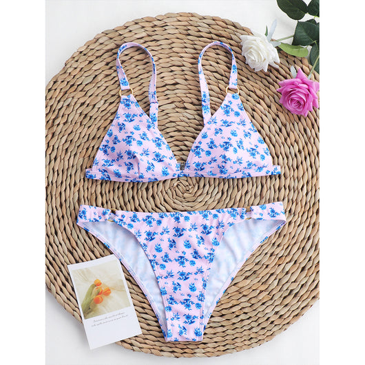 Woman smiling in a white bikini with blue floral print, triangle top, and briefs bottoms, on a sunny beach. - Image 88