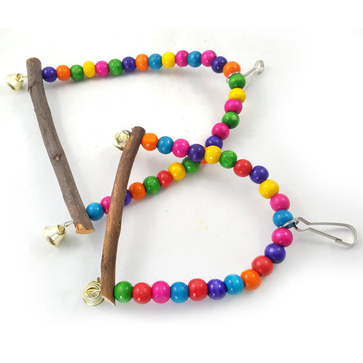 Blue and yellow macaw parrot on a colorful wooden bead swing with bells, designed for bird cages. - Image 2