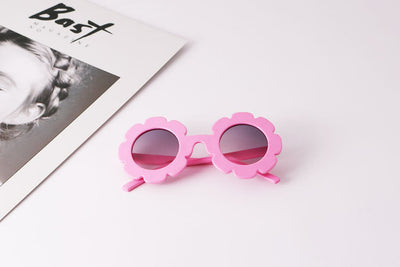 Light blue flower-shaped sunglasses with dark lenses, featuring a playful design and plastic frame. - Image 8