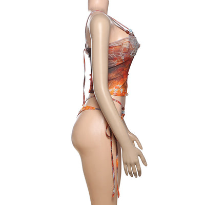 Women's fashionable three-piece bikini set with an abstract orange, brown, and blue print. Features a triangle top, mesh mini skirt, and lace-up details with be - Image 15