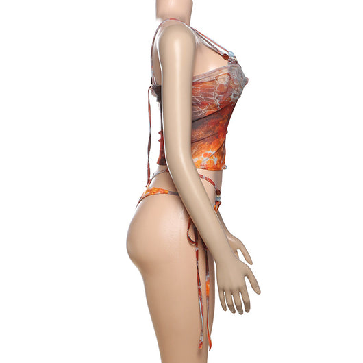 Women's fashionable three-piece bikini set with an abstract orange, brown, and blue print. Features a triangle top, mesh mini skirt, and lace-up details with be - Image 15