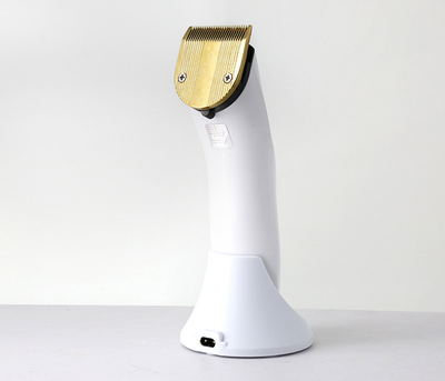 White and silver Kemei KM-1830 electric hair clipper with a charging base on a light background. - Image 3