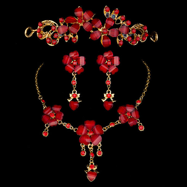 Red floral and heart gemstone bridal jewelry set with gold-toned tiara, necklace, and dangle earrings.