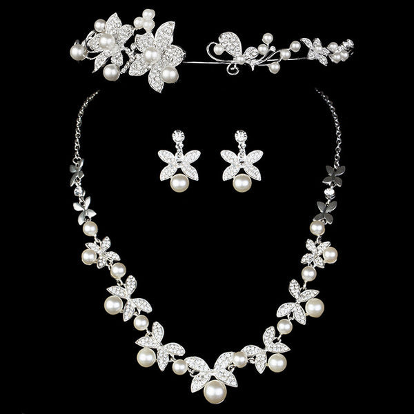 Elegant bridal jewelry set featuring a pearl and rhinestone floral necklace with matching drop earrings on a model.