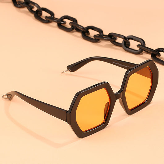 Octagonal sunglasses with brown gradient lenses and a tortoiseshell chain strap on a white background.