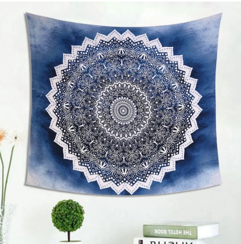 Cool blue mandala tapestry with intricate white patterns, perfect for wall hanging in a dorm room or living space.