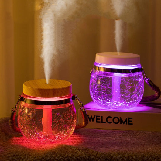 Desktop humidifier with a clear, crackled glass base, white lid, and a brown rope handle. - Image 14