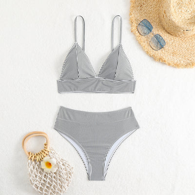Green and white striped two-piece bikini with a triangle top and high-waisted bottoms on a woman. - Image 23