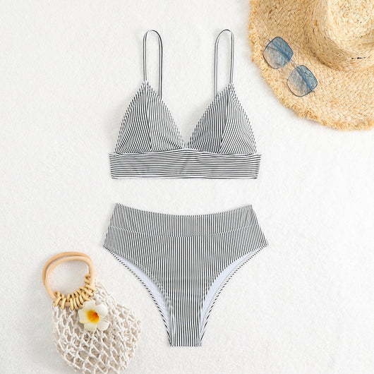 Green and white striped two-piece bikini with a triangle top and high-waisted bottoms on a woman. - Image 23