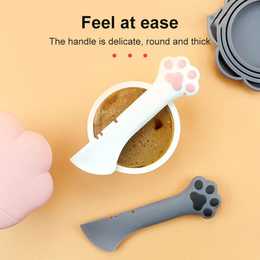 Gray pet food spoon with a paw print handle and a matching paw-shaped can opener lid. - Image 4