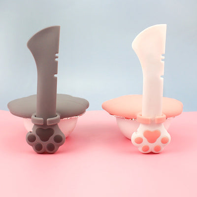 Gray pet food spoon with a paw print handle and a matching paw-shaped can opener lid. - Image 10