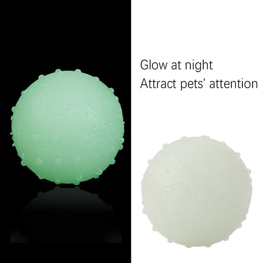 Interactive pet glow ball, off-white in daylight and glowing green in the evening, with a textured surface.