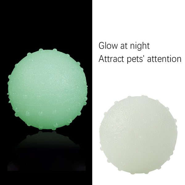 Interactive pet glow ball, off-white in daylight and glowing green in the evening, with a textured surface.